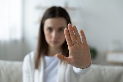 Stylised photo of woman gesturing to stop.