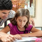 Father teaches daughter in home school