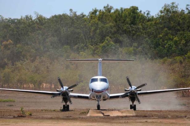 Royal Flying Doctor Service plane touches down on dusty airstrip