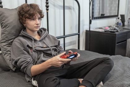 Teen girl playing videogames instead of being at school