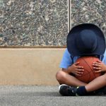 Boy in school uniform holding a basketball