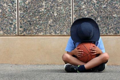 Boy in school uniform holding a basketball