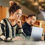 Woman works on laptop in an office