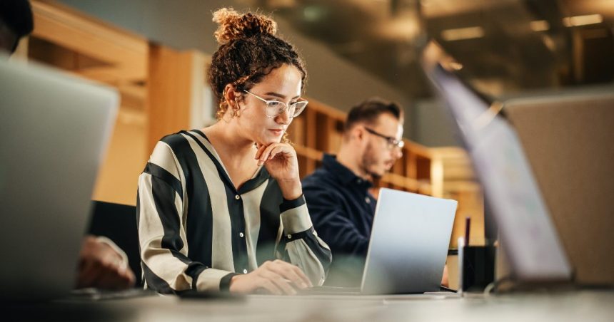 Woman works on laptop in an office